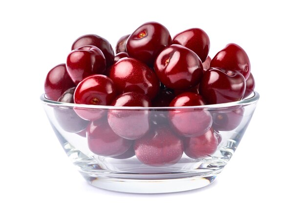 Glass bowl of sweet cherry fruits isolated on white