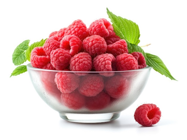 Glass bowl with raspberries and green leaves on a white background