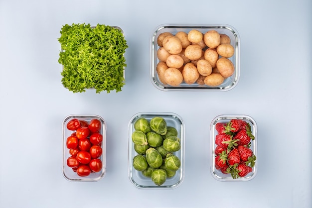 Glass boxes with fresh raw vegetables Vegetables and fruits in glass containers Food storage concept