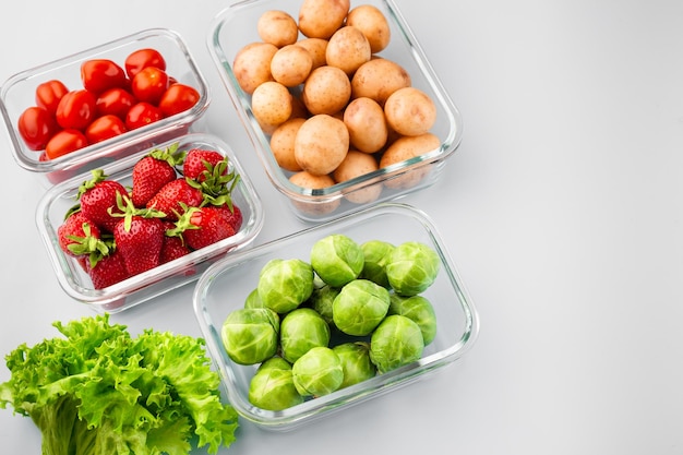 Glass boxes with fresh raw vegetables Vegetables and fruits in glass containers Food storage concept