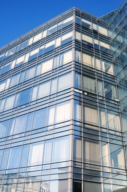 A glass building with a blue sky behind it