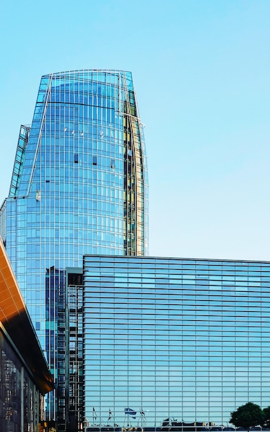 Glass Business office building architecture, Modern City. Urban corporate skyscraper exterior and skyline. Windows design. Blue sky in background. Cityscape