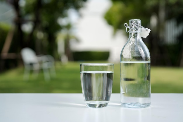 A glass of clean drinking water and a water bottle