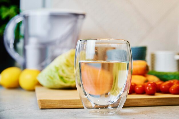 Glass of clean water and vegetables