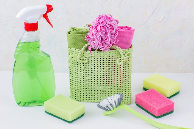 Glass cleaner, sponge, brush and towels and flower in the bag