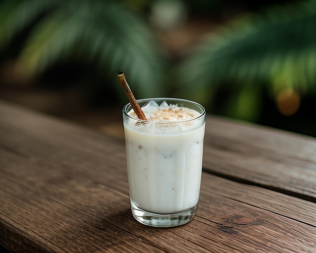 Photo glass of coconut juice with blurred coconut tree background