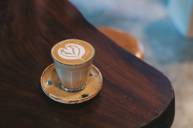 A glass of coffee latte art on table.