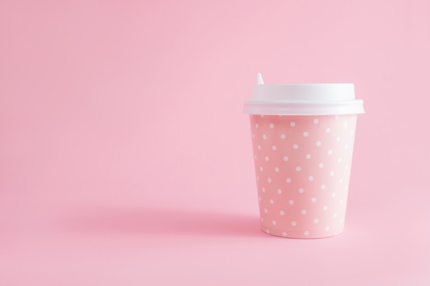 Glass of coffee take-away on pink. Coffee time. With copyspace.