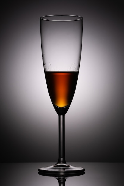 A glass of cognacon gray