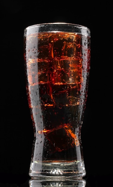 Glass of cola with ice on black background