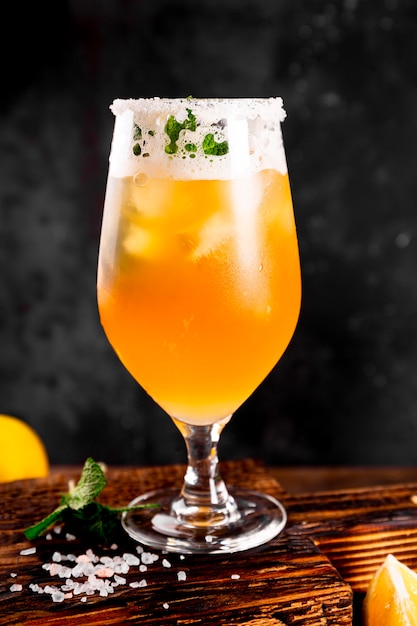 A glass of cold beer with lemon and mint, traditional latin american drink michelada