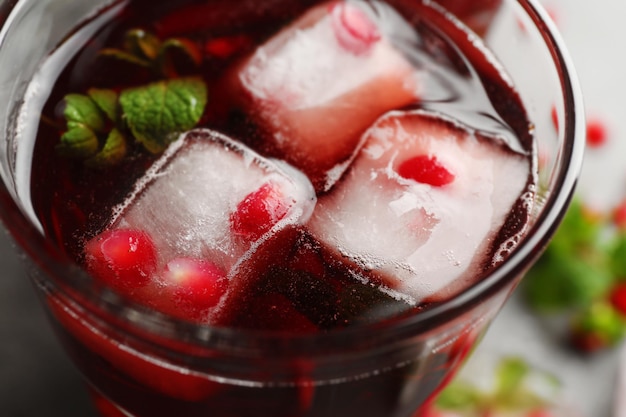 Glass of cold fruit cocktail closeup