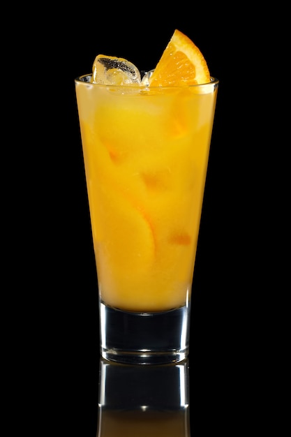 Glass of cold orange lemonade isolated on black