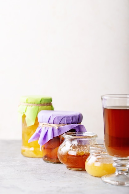 Glass cup of black tea served with honey