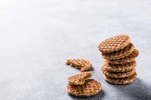 Glass cup of coffee with syrupwaffles cookies