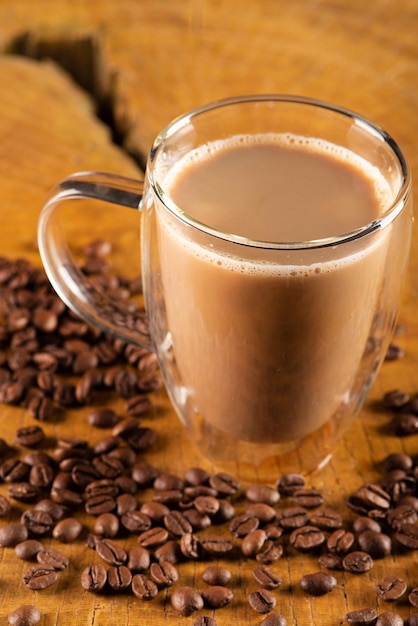 Glass cup glass cup with milk and coffee on rustic wood selective focus