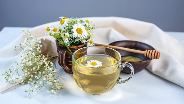 Glass cup of hot chamomile tea