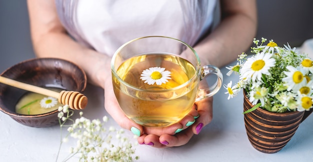 Glass cup of hot chamomile tea