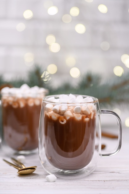 Glass cup of hot cocoa with christmas tree