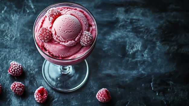 a glass cup of ice cream with raspberries and raspberries