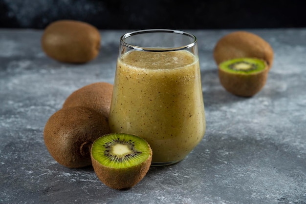 A glass cup of tasty juice with kiwi fruits