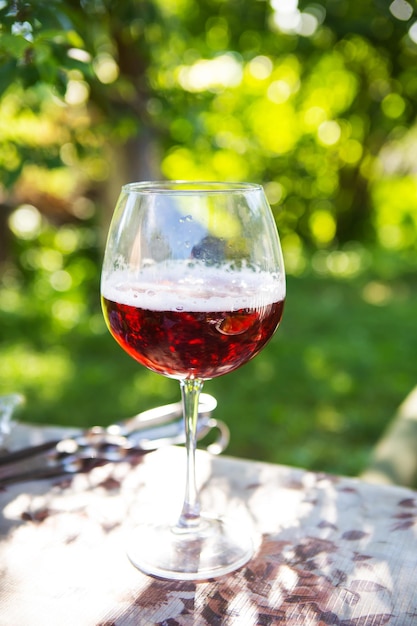 A glass of dark beer in a glass standing on a table outdoor recreation Summer picnic