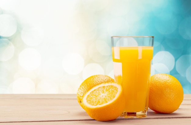 Glass of delicious orange juice on table