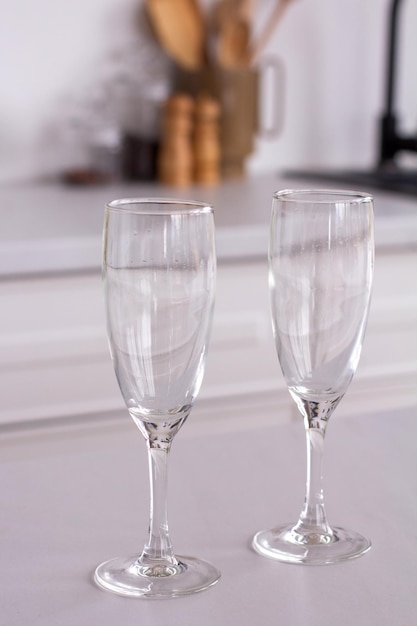 Glass dirty wine glasses on table on kitchen background