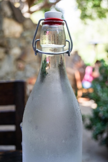 Glass fancy serving cold water bottle at a restaurant