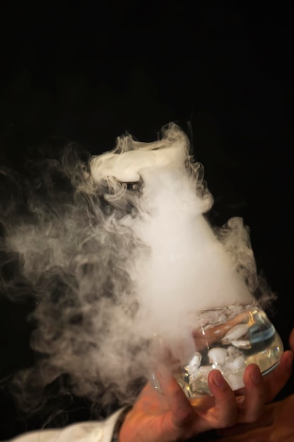 Glass flask with puffs of smoke as a result of liquid nitrogen reaction