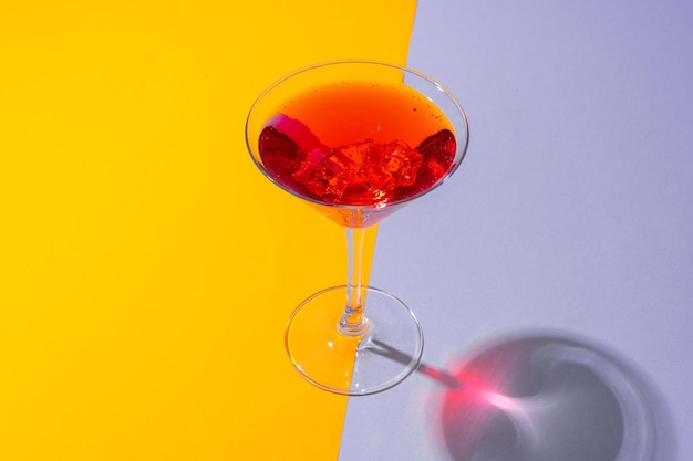 Glass of fresh cocktail on color background