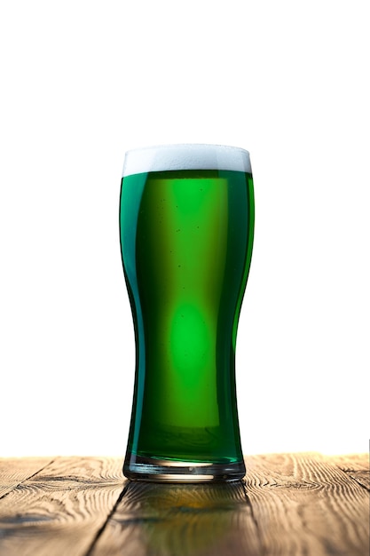 Glass of fresh cold green beer on a wooden table Isolated