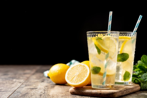 Glass of fresh lemonade on wooden table