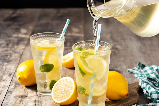 Glass of fresh lemonade on wooden table