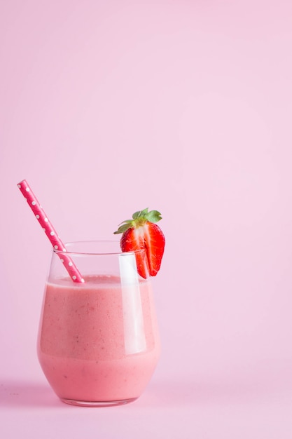 Glass of fresh strawberry milkshake, smoothie and fresh strawberries