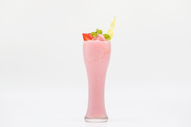 Glass of fresh strawberry smoothie on white background