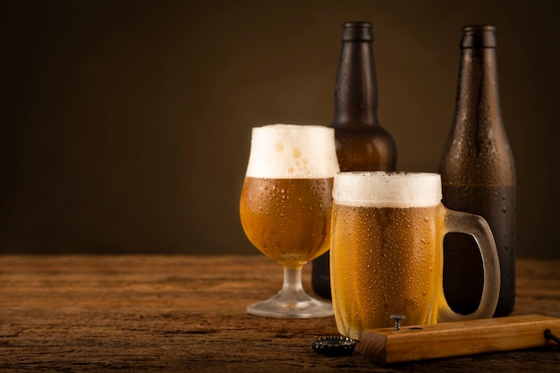 Glass full of cold beer on the wooden table