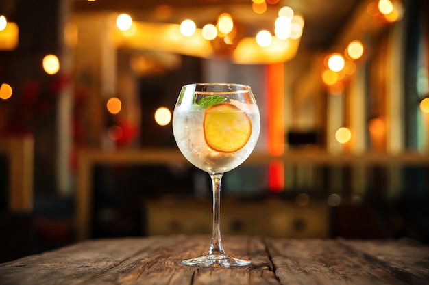 Glass of gin tonic cocktail with orange slice