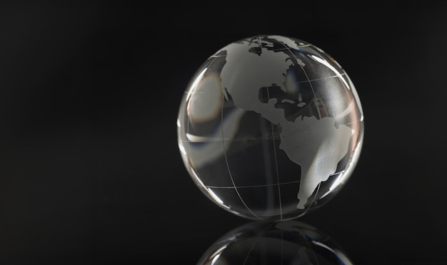 Photo glass globe on a black background reflection of a circle