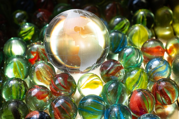 Glass globes of planet earth placed among marble balls Preservation of the environment