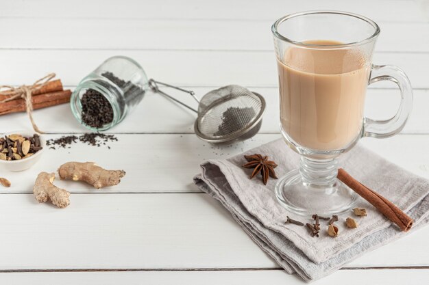 A glass of hot Indian masala tea brewed with aromatic spices and milk