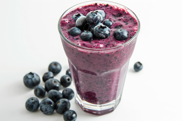 A glass of iced blueberry smoothie with blueberries