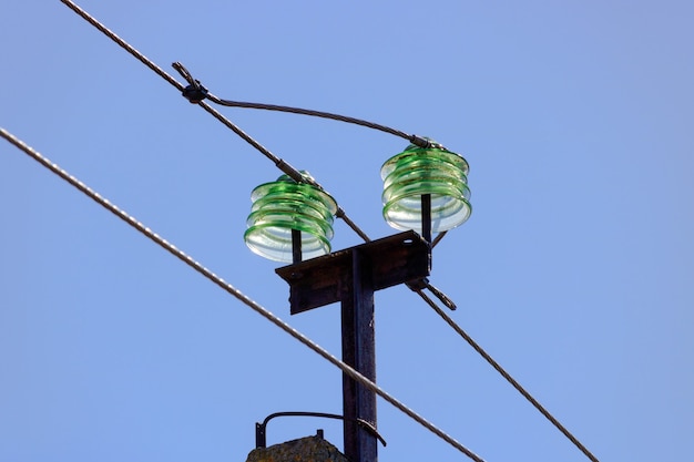 Glass insulators of transmission line supports against blue sky