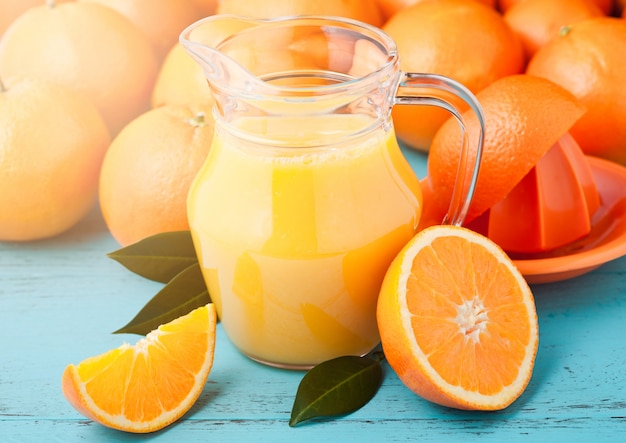 Glass jar of fresh orange juice with fruits