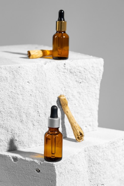 Glass jar of skincare serum on concrete block close up