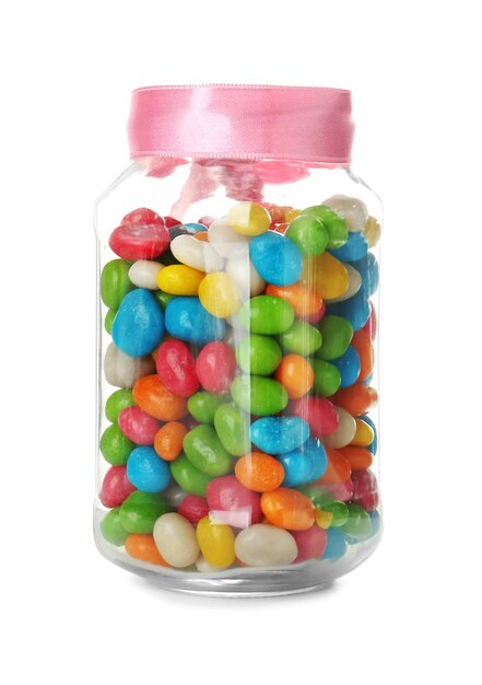 Glass jar with colorful candies on white background