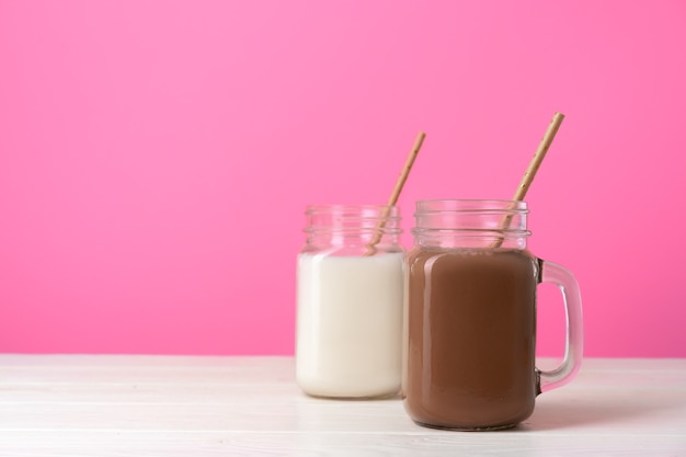 Glass jars with flavored milkshakes