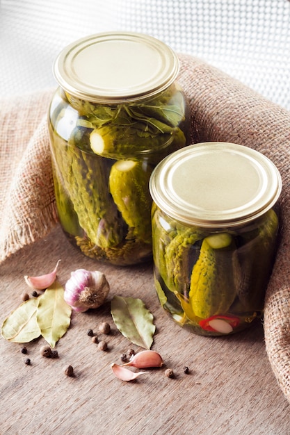 Glass jars with homemade pickles, sealed with metal lid