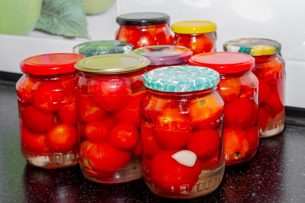 Glass jars with red tomatoes filled with brine Preparations for the winter canning tomatoes