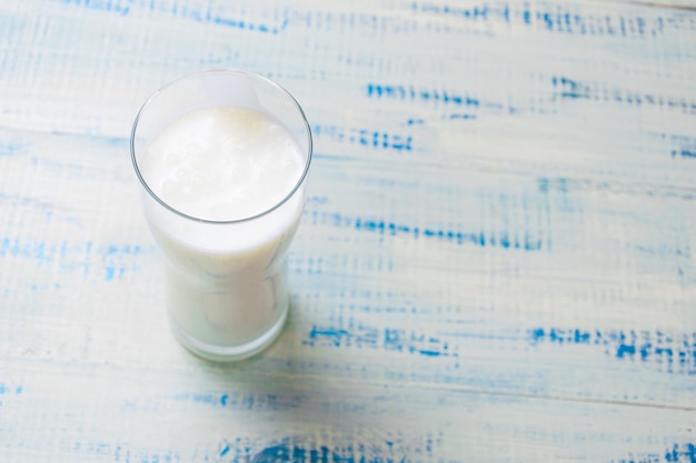 A glass of kefir a fermented milk product on a wooden background